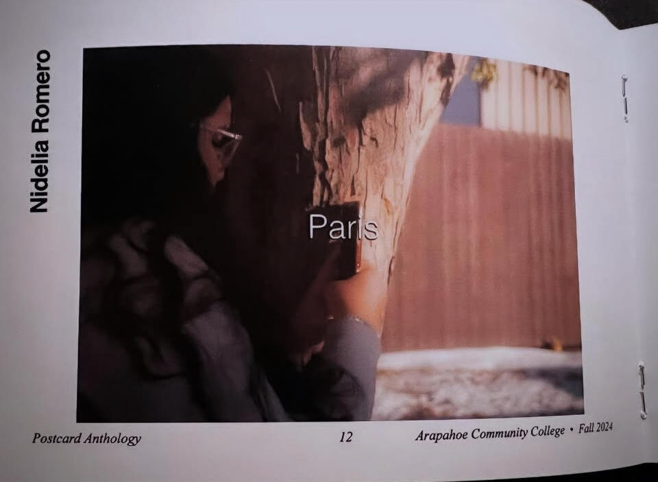 The photograph shows a woman staring down at her phone. The title of the piece, "Paris," is displayed in white letters at the center of the photograph.